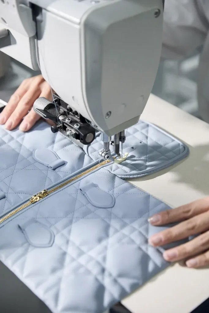 Sewing machine stitching blue fabric