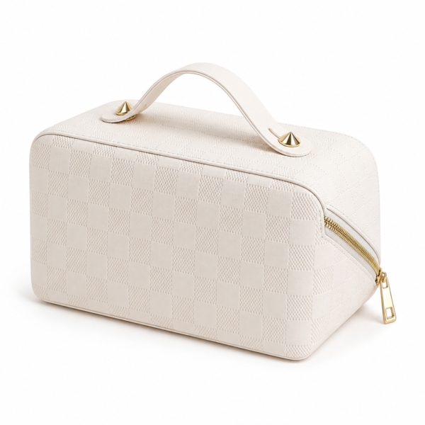 Close-up of gold-tone zipper and patterned cosmetic bag exterior