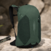 登山包3产品展示图G Forest green hiking backpack displayed in an outdoor setting