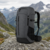 Multi-pocket hiking backpack displayed in a mountain environment